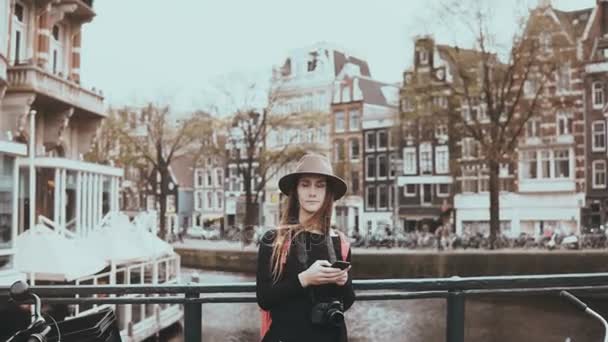 Portrait of nervous pretty female with smartphone. 4K. Adult Caucasian 30s woman hesitating and confused on a bridge. — Stock Video