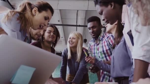 Young team working on new project. Group of mixed race people standing near the table and discussing. — Stock Video