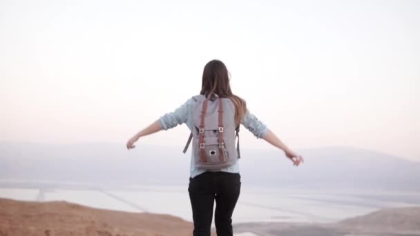 Girl at mountain top, arms wide open. Slow motion. Pretty European woman traveler excited. Happiness. Israel desert. — Stock Video