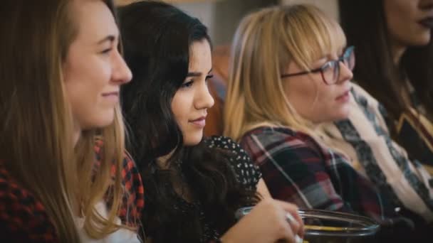 Europese meisjes trieste film kijken op de Bank. Jonge aantrekkelijke dames Bekijk soap opera, popcorn eten. Verlijmen van tijd 4k. — Stockvideo