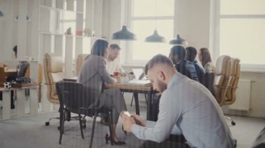 Dolly çok ırklı iş karşılaşma içinde modern ofis bir kadeh. Smartphone 4 k kullanarak genç başarılı Avrupa iş adamı.