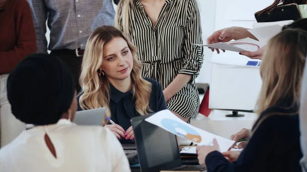 Young happy smiling confident blonde businesswoman very busy at work with colleagues at modern office meeting table. — ストック写真