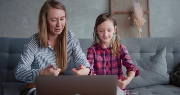 Homeschooling concept. Happy beautiful young mother teaching cute cheerful teenage daughter study on vacation at home. — Stock Video