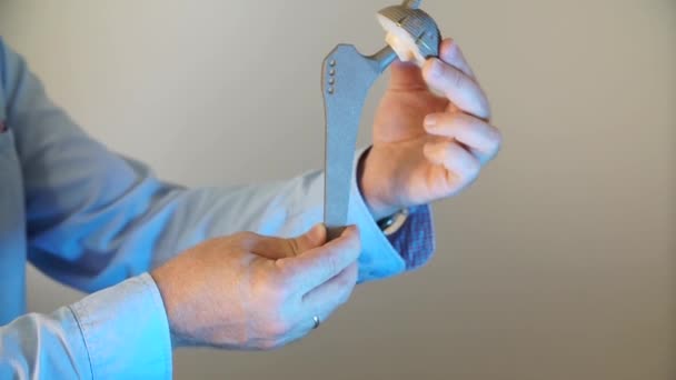 Closeup of a hip prosthesis in the doctor's hands — Stock Video