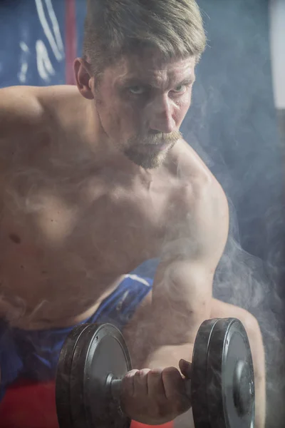 Handsome man boxing with red boxing gloves