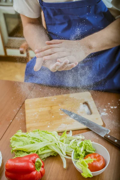 hands chef in the flour shake