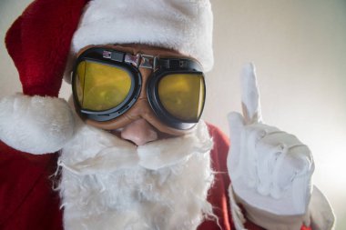 Noel Baba kostümü giymiş sakallı yaşlı bir adamın portresi komik suratını buruşturuyor.