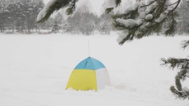 tent in the snow during snowfall