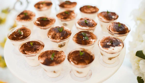 Some tiramisu on a white round table. — Stock Photo, Image