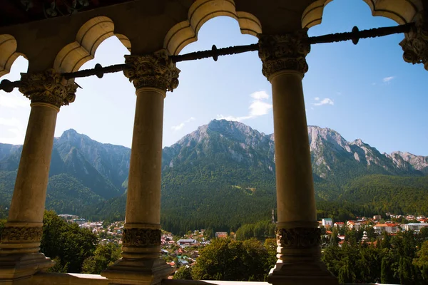 Photo of antique columns on beautiful mountains scape and city,