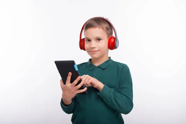 Photo of happy boy using tablet and looking confident at the cam — Stock Photo, Image