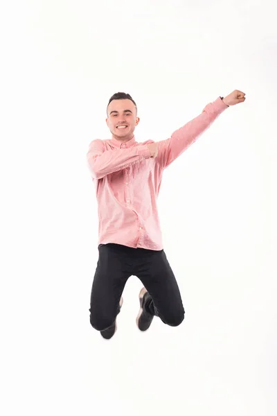 Photo of young man in red shirt jumping over white background — Stock Photo, Image