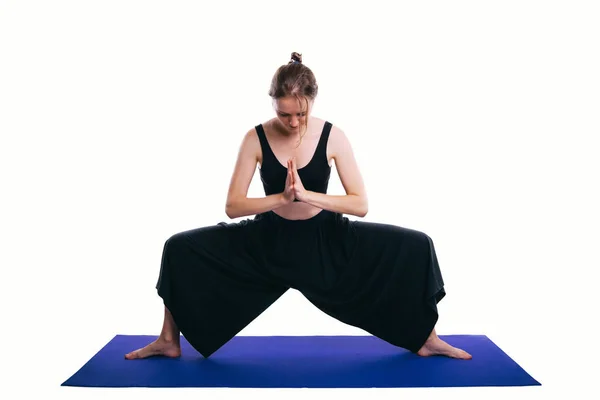 Photo de jeune femme faisant du yoga pose de la déesse sur fond blanc — Photo