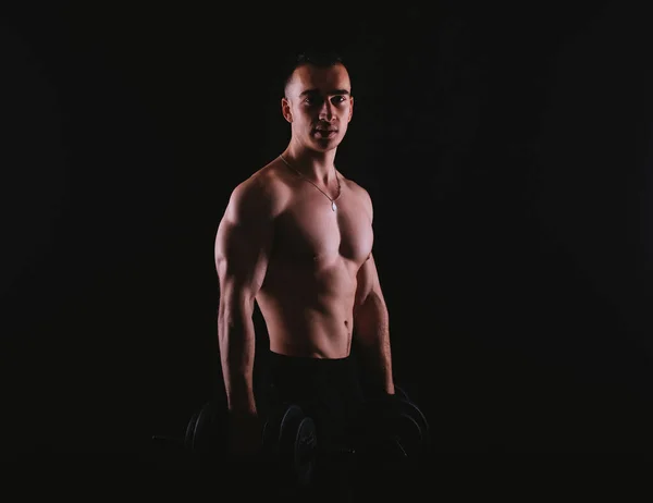 Photo of young muscular man working with weights — 스톡 사진