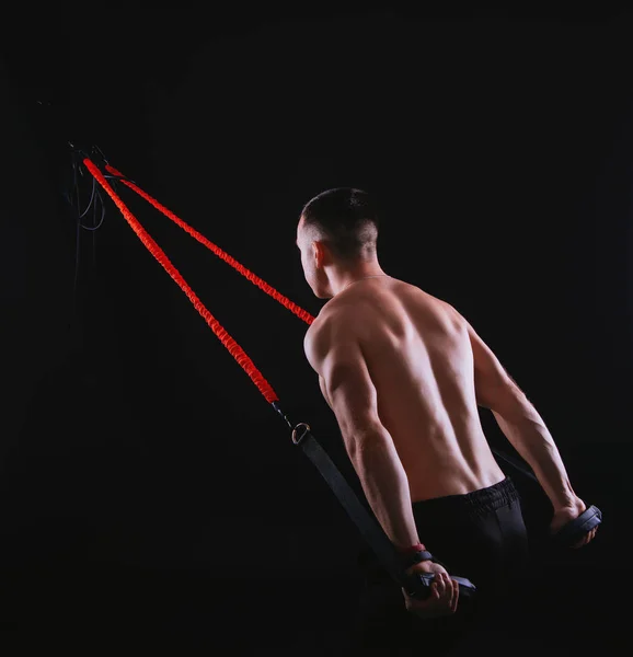 Photo of  man doing TRX training in gym. exercise with elastic r — 스톡 사진