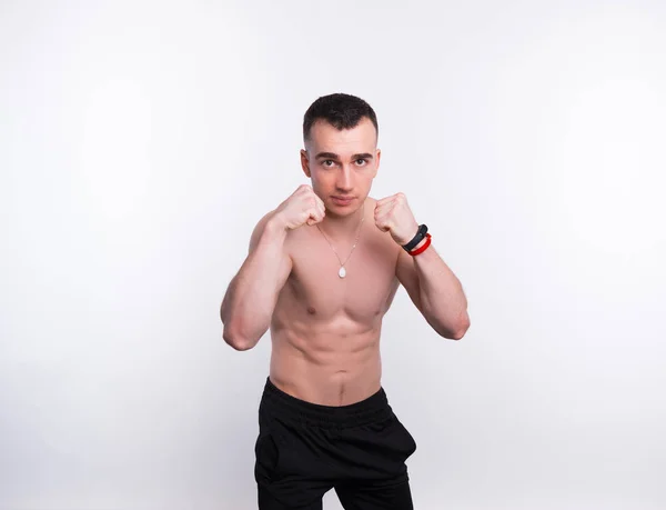 Young man fighter posing over white background — 스톡 사진