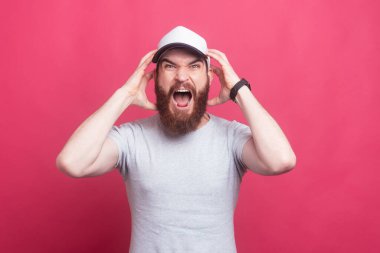 Angry man screaming at camera, photo of frustrated man