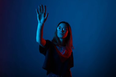 Tounching the future. Young pretty girl si holding one hand up, 