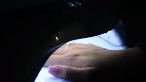 Woman hand in ultra violet lamp — Stock Video