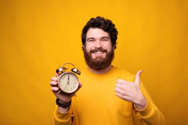 Zaman ayırdığınız için teşekkürler, sakallı adam jest yapıyor ve elinde çalar saat tutuyor..