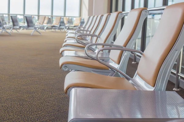 Empty chairs in airport waiting area
