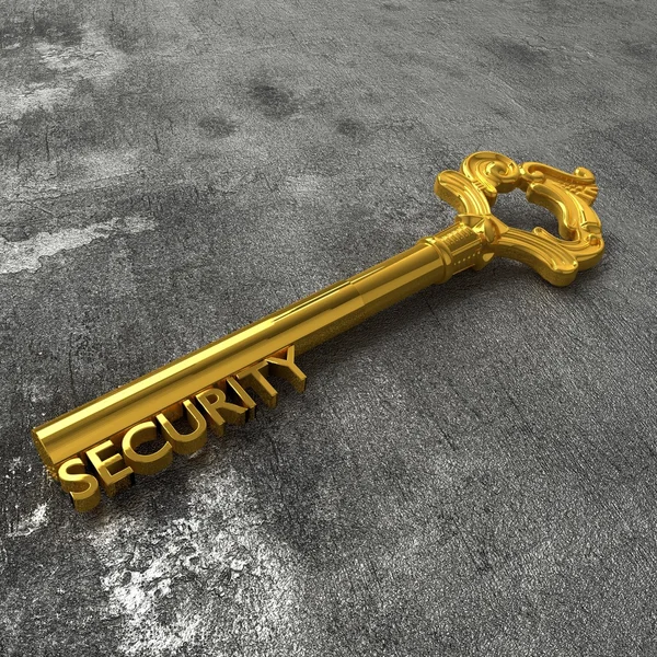 Chave de segurança dourada na mesa de pedra preta — Fotografia de Stock