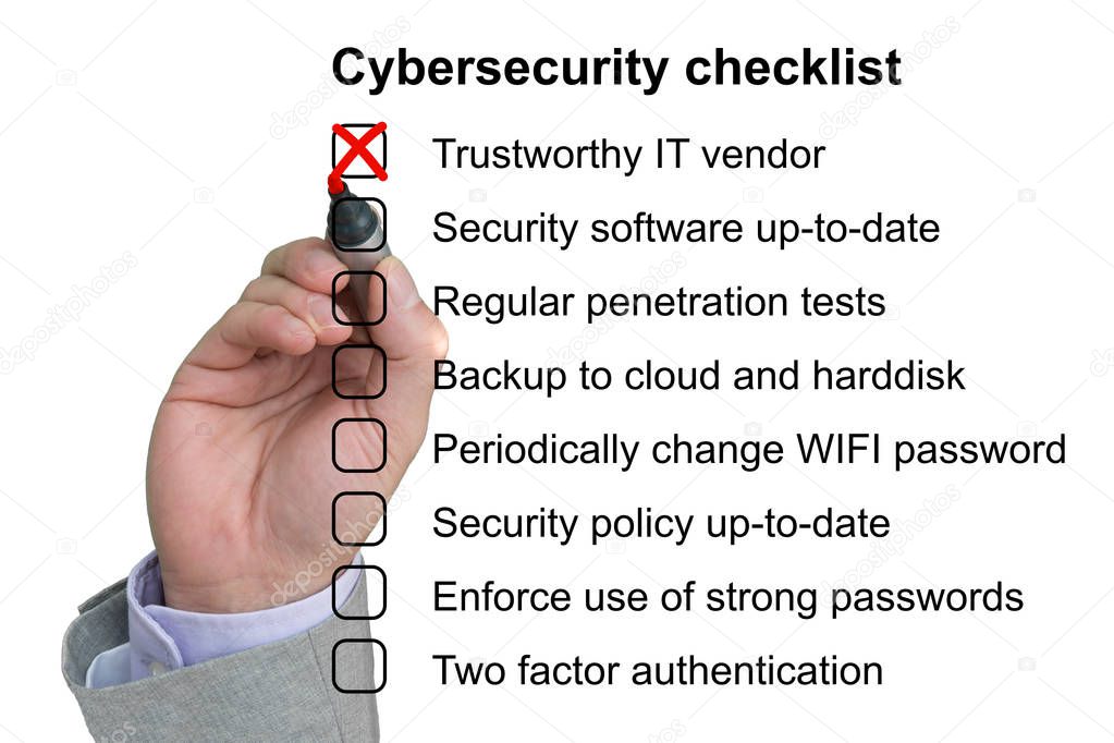 Hand crosses off the first item of a cybersecurity checklist