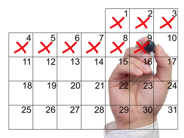 La mano cruza los días en rojo del calendario —  Fotos de Stock
