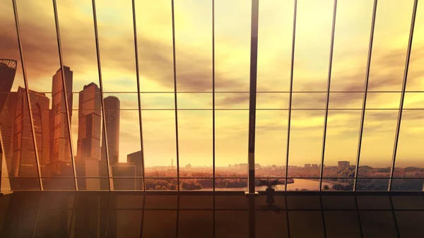 Leeres Büro mit Blick auf das Stadtbild mit Wolkenkratzern und einem Fluss bei Sonnenuntergang. — Stockfoto