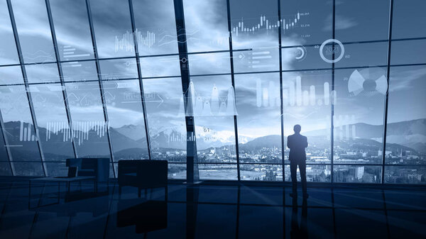 Businessman in his office analyzes the virtual infographic data on the background of a large panoramic window overlooking the snow-capped peaks of the mountains.