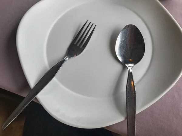 Close up of empty white plate fork and spoon — Stok Foto