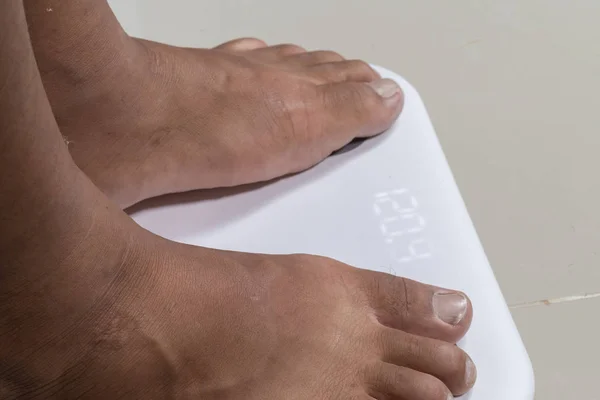 Close up of man feet and digital smart scale — 스톡 사진