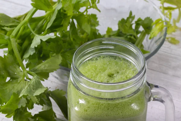 Close up of fresh green celery juice on glass — Stock Photo, Image