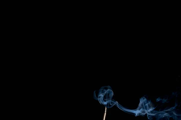 Abstract smoke of joss stickon black background — Stock Photo, Image