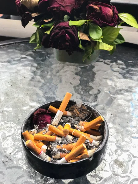 Outdoor Ashtray full of smoked on the table — Stock Photo, Image