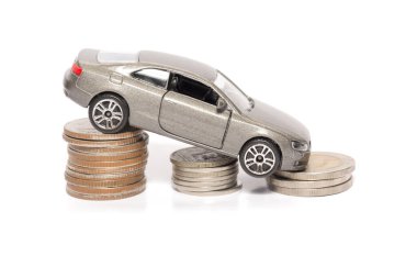 toy car and stack of coin isolated on white background