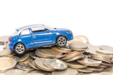 toy car and stack of coin isolated on white background