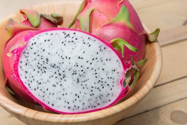 close up of dragon fruit on wooden bowl