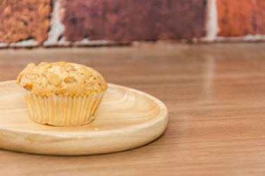 cup cake with almond topping on handle round plate