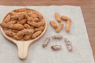 close up of boiled peanuts on wooden plate