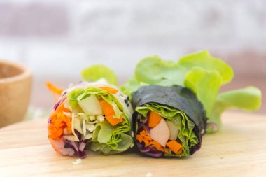 close up of vegetable salad roll and sauce
