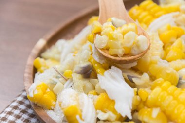 Sweet Corn with coconut and sugar on wooden plate