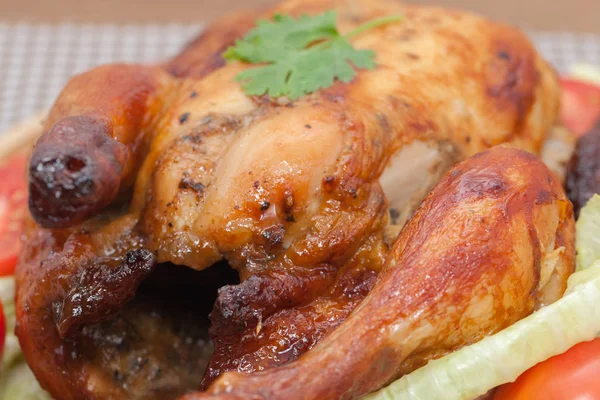 Close up of roast chicken on wooden plate — 스톡 사진