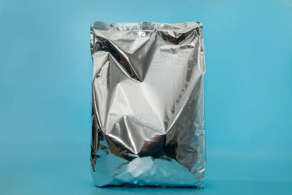 close up of snack foil bag on blue background