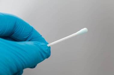 Mavi eldiven ve pamuklu cımbız.