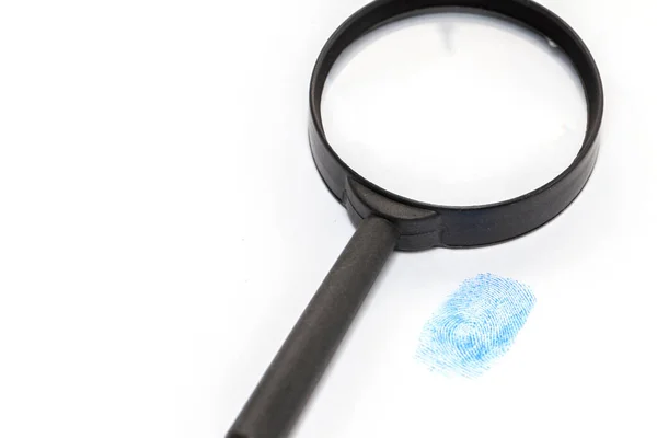 Hand in blue glove and magnifying glass — Stock Photo, Image