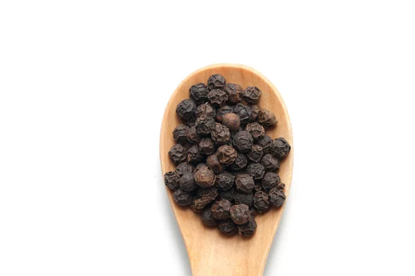 Pile of pepper on wooden spoon isolated on white background — Stock Photo, Image