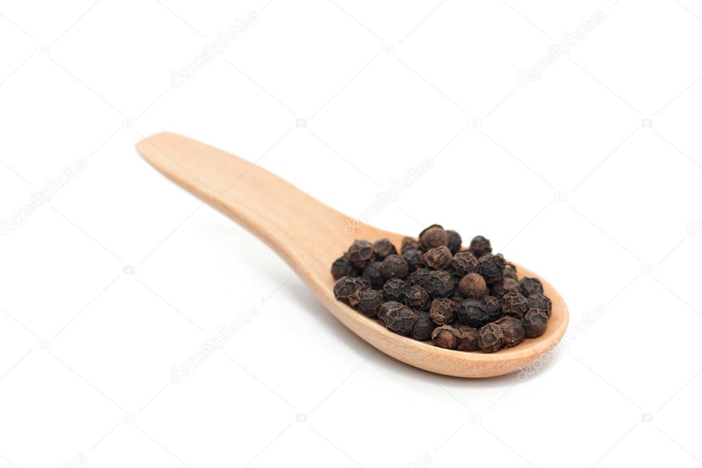 Pile of pepper on wooden spoon isolated on white background 
