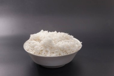 cooked rice on bowl on black background