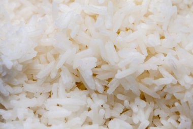 cooked rice on bowl on black background
